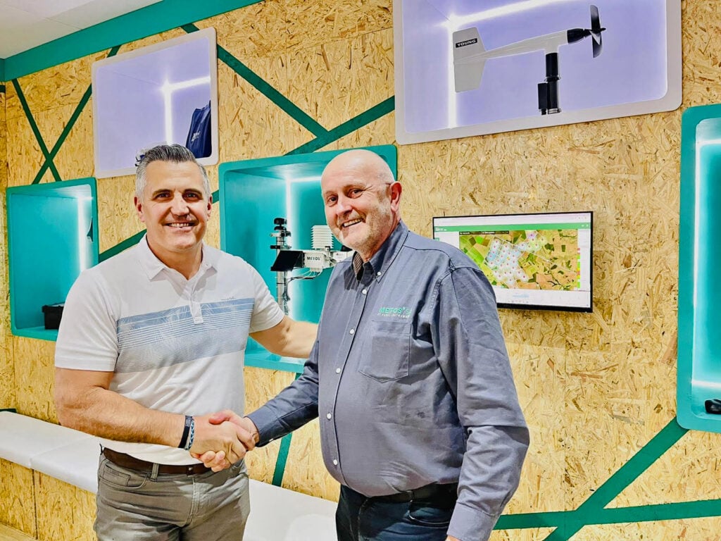 Густаво Оберто, президент компанії Lindsay Global Irrigation, і Готфрід Пессл, генеральний директор і засновник Pessl Instruments, потискають один одному руки на виставці Agrishow, Бразилія, у травні 2023 року
